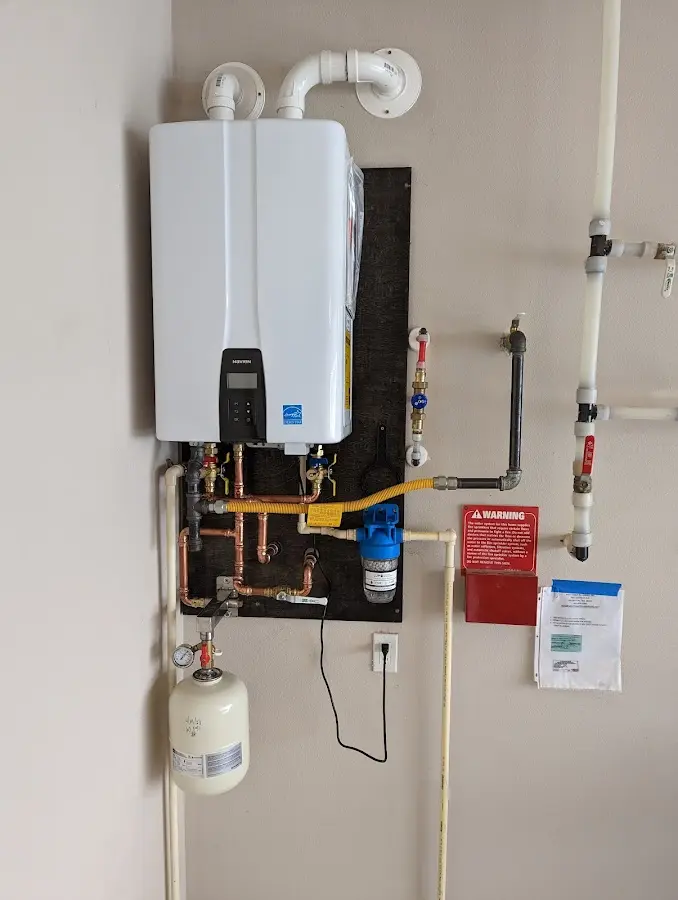 Professional plumber installing copper piping in a Atherton home